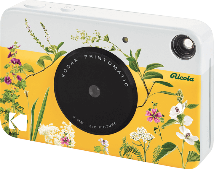 Macchina fotografica Kodak Printomatic. Colore bianco e giallo, con decorazioni floreali.
